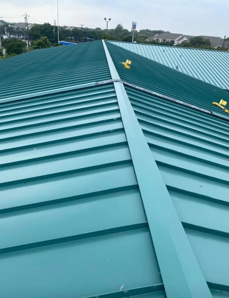 Green commercial metal roof ridge and valley for Metal Roof Repair in Champlain